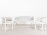 two white chairs and a table in a room with a white wall