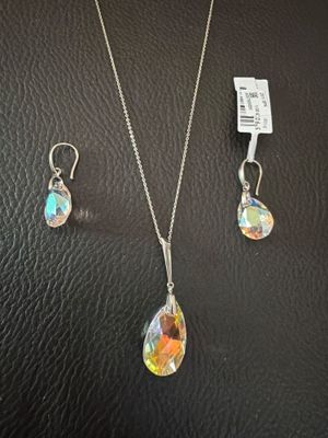 a necklace and earring set with a glass tear shaped pendant