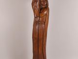 wooden statue of a woman holding a child in her arms