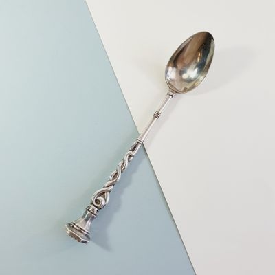 silver spoon on a blue and white background with a silver handle