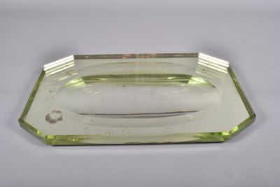 an image of a green glass tray with a knife in it