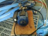 a blue blower sitting on top of a piece of wood