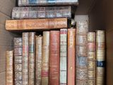 a box full of old books sitting on top of a table