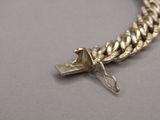 a silver chain with a cross on it