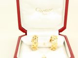 two gold rings in a red box on a white surface