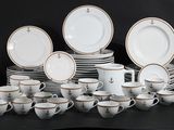 a lot of plates and cups on a black table