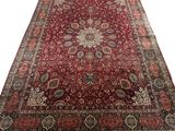 a red rug with a medallion design on it