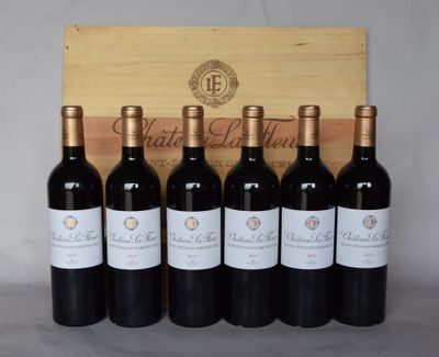 six bouteilles de vin sont alignées devant une caisse en bois