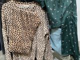 a rack of clothes that has a leopard print shirt on it