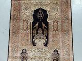 an oriental rug hanging on a wall in a room