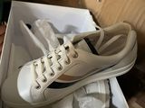a box with a pair of white shoes in it