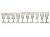 six wine glasses lined up in a row on top of each other