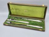 a silverware set in a green box on a table