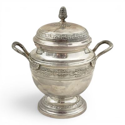 an antique silver plated bowl with two handles and a lid