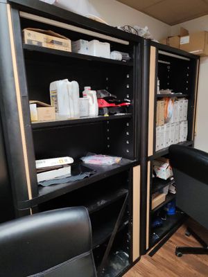 a desk with a computer and a chair in a room