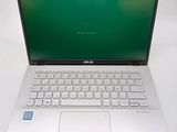 an open laptop computer sitting on top of a white table