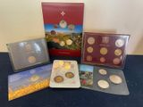 a bunch of coins are sitting on a table next to a book