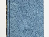 a blue book sitting on top of a white table