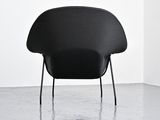 an image of a black chair in a white room