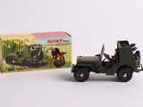 toy army jeep and box of dinky toys on a white surface