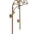 brass wall sconce with two candles on each side of it