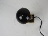 a close up of a black lamp on a white surface