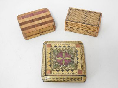 three small wooden boxes sitting on top of a white surface