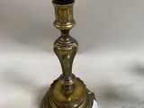 pair of antique brass candlesticks on a white background