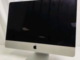 a computer monitor sitting on top of a white table