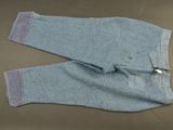 pair of blue jeans with zippers on them laying on a table