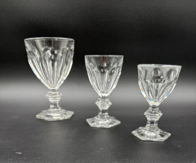 three glass goblets sitting on top of a table next to each other