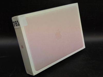 a white box with a pink cover sitting on a black surface