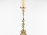 a silver candle holder with a candle on top of it