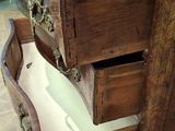 a wooden dresser with two drawers and a marble top