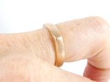 a person ' s hand with a ring on it ' s finger