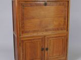 an image of a wooden cabinet with drawers and a door
