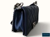 the small blue purse is sitting on a white surface