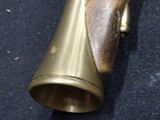 a small brass object that is on a blue carpet