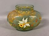 a glass vase with a flower on it on a table