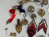 a lot of badges and pins on a white surface