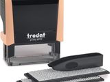 a rubber stamper with a keyboard and mouse on a white background