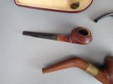 a pipe, a pipe holder, and a pipe holder on a table