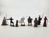the figurines are lined up in a row on a white surface