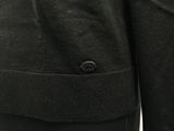 a close up of the back of a jacket with a button on it