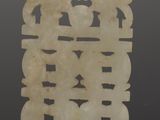 an image of a white jade plaque on a black surface