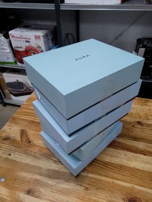three blue boxes stacked on top of each other on a wooden table