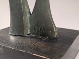 sculpture of a pair of feet on a wooden block