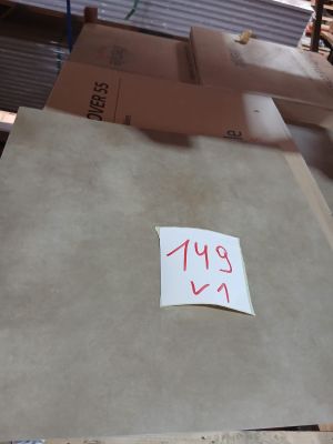 a piece of cardboard sitting on top of a pile of boxes
