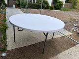 a white table that is sitting on the ground