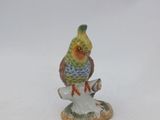 a figurine of a bird sitting on top of a tree stump
